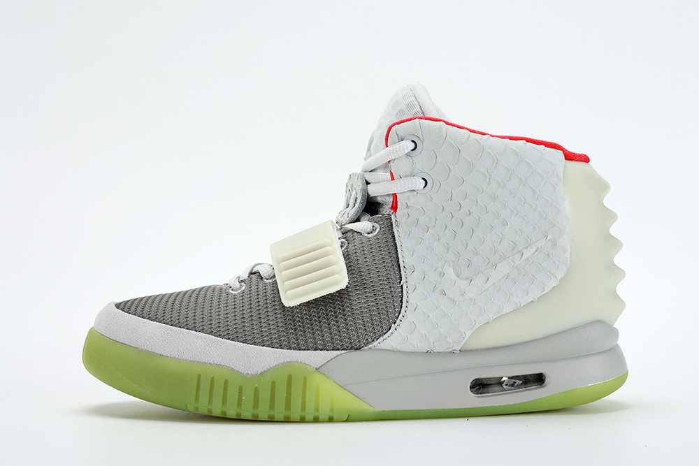 The Air Yeezy 2 NRG 'Pure Platinum' launched in June 2012 featuring a subdued colorway that blends varying shades of grey on the upper and a contrasting pop of bright red on the collar lining.